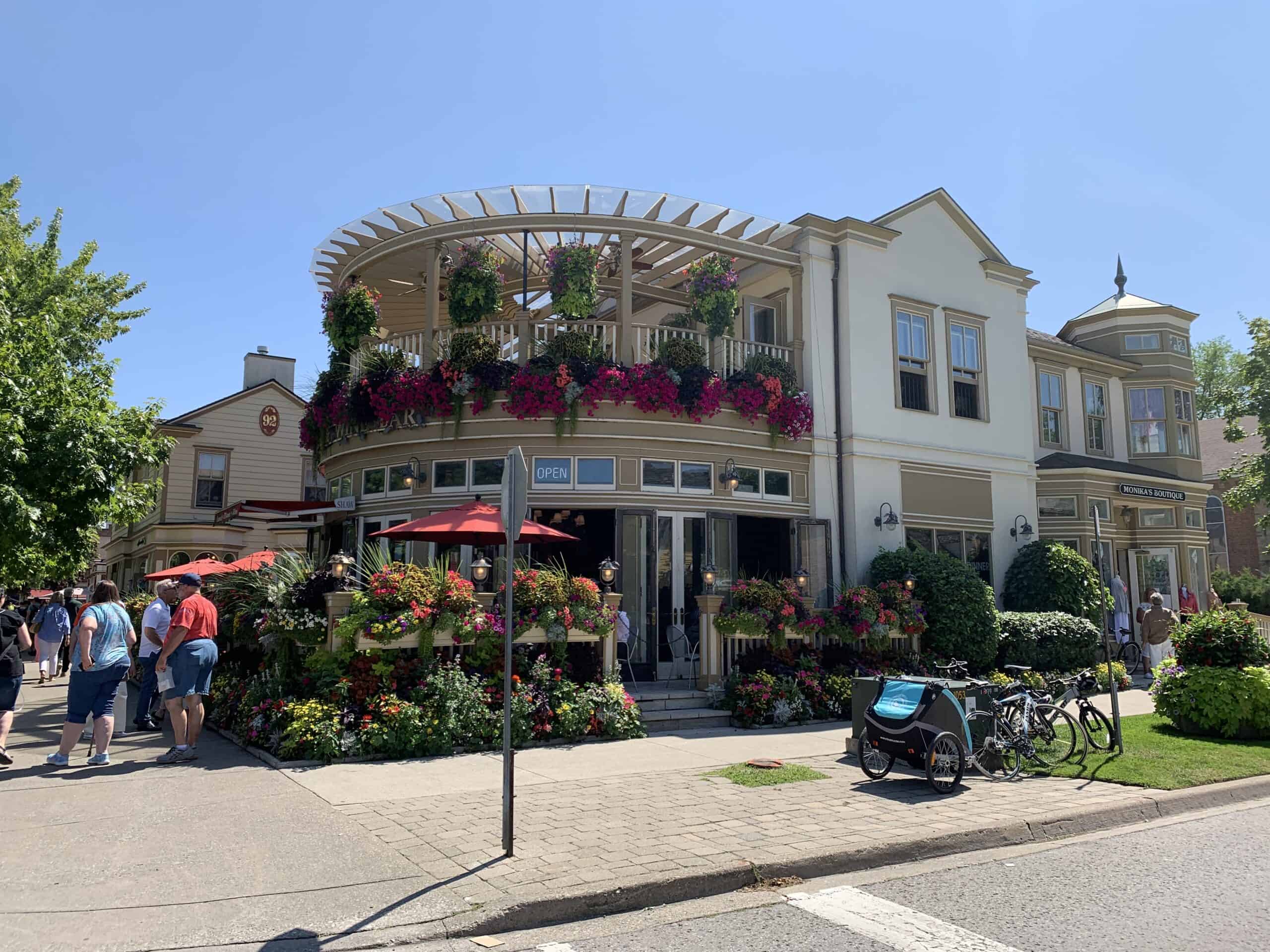 NOTL Restaurant & Bar covered in flowers on a sunny, summer day on Queen Street.