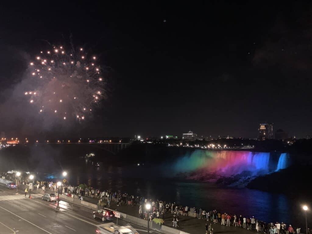 Fireworks over the illuminated Niagara Falls