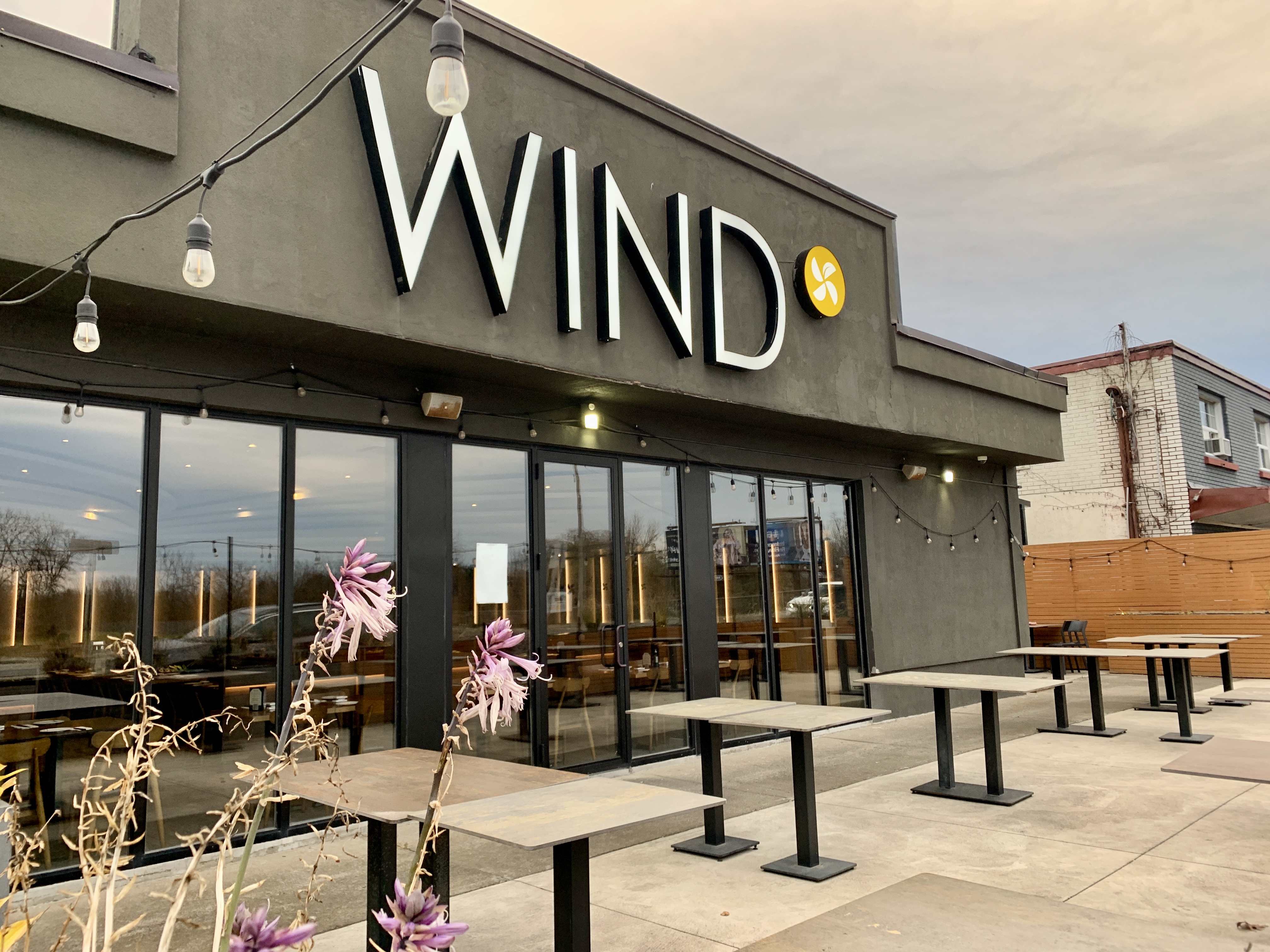 Wind is a Japanese restaurant in Niagara Falls with a dark grey exterior and the large name on the fornt.